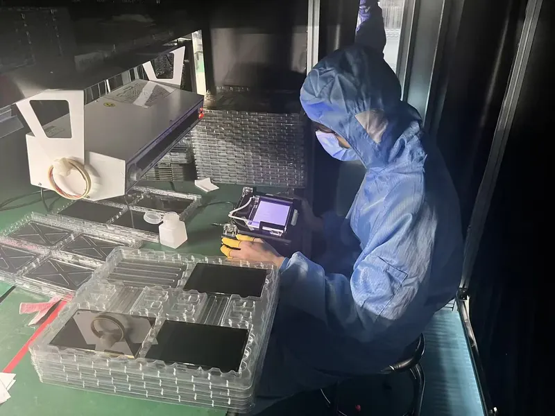 DISEA operator inspecting a display module at an inspection station